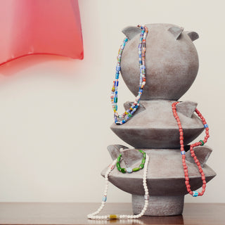 Layout with Dar Leone jewellery featuring ceramics, necklaces and bracelets.